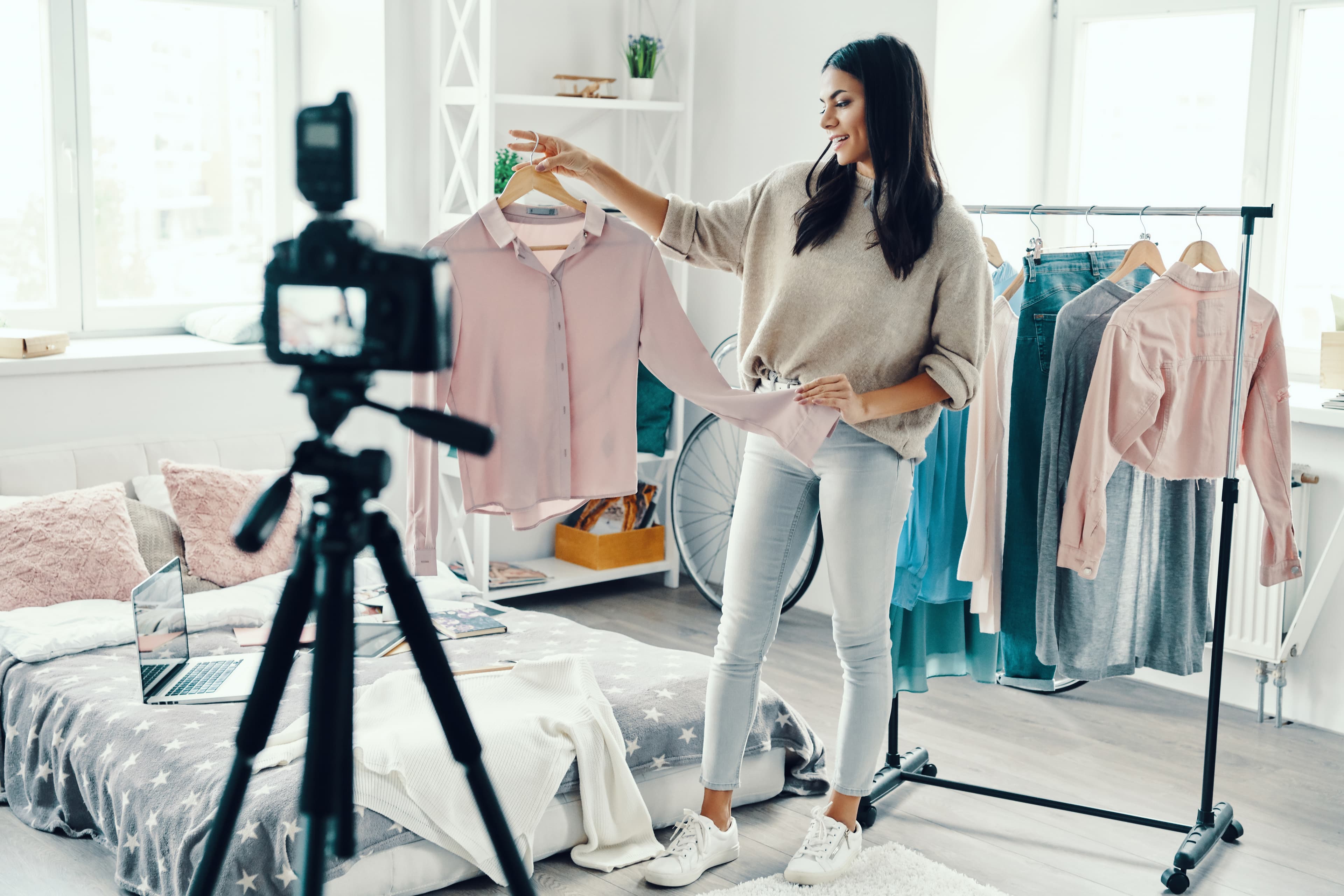 young woman in casual clothing making social media video while spending time at home