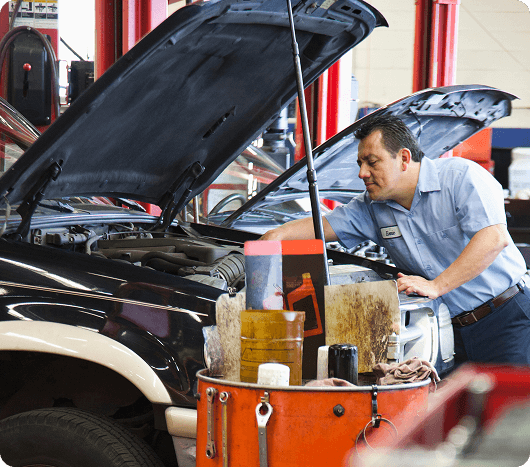 hispanic-mechanic-leans-into-an-engine-of-a-car-he-2025-04-03-08-00-35-utc 1 (1)