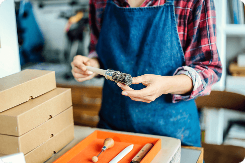 detail-of-hands-holding-paintbrush-in-book-arts-st-2025-04-04-12-43-41-utc 1 (1)